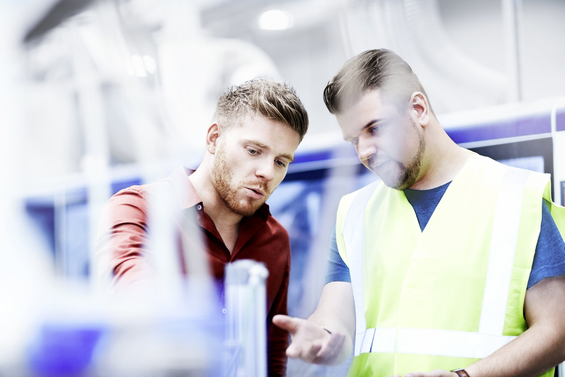 © iStock-535474757_stocknroll (Young manager and foreman looking at machine on production line)